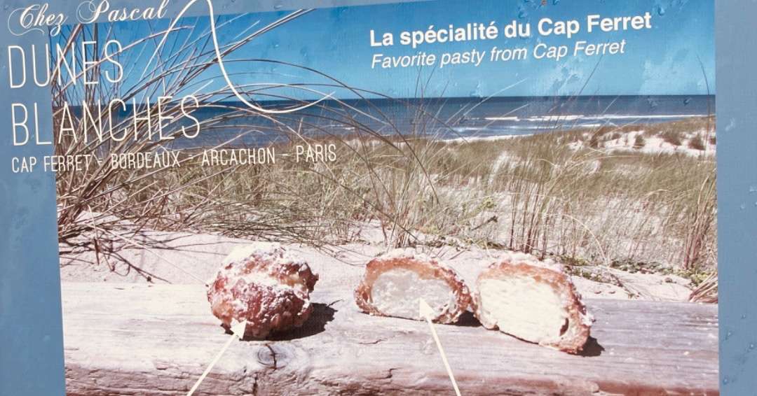 Sign showing a sweet pastry from Cap Ferret